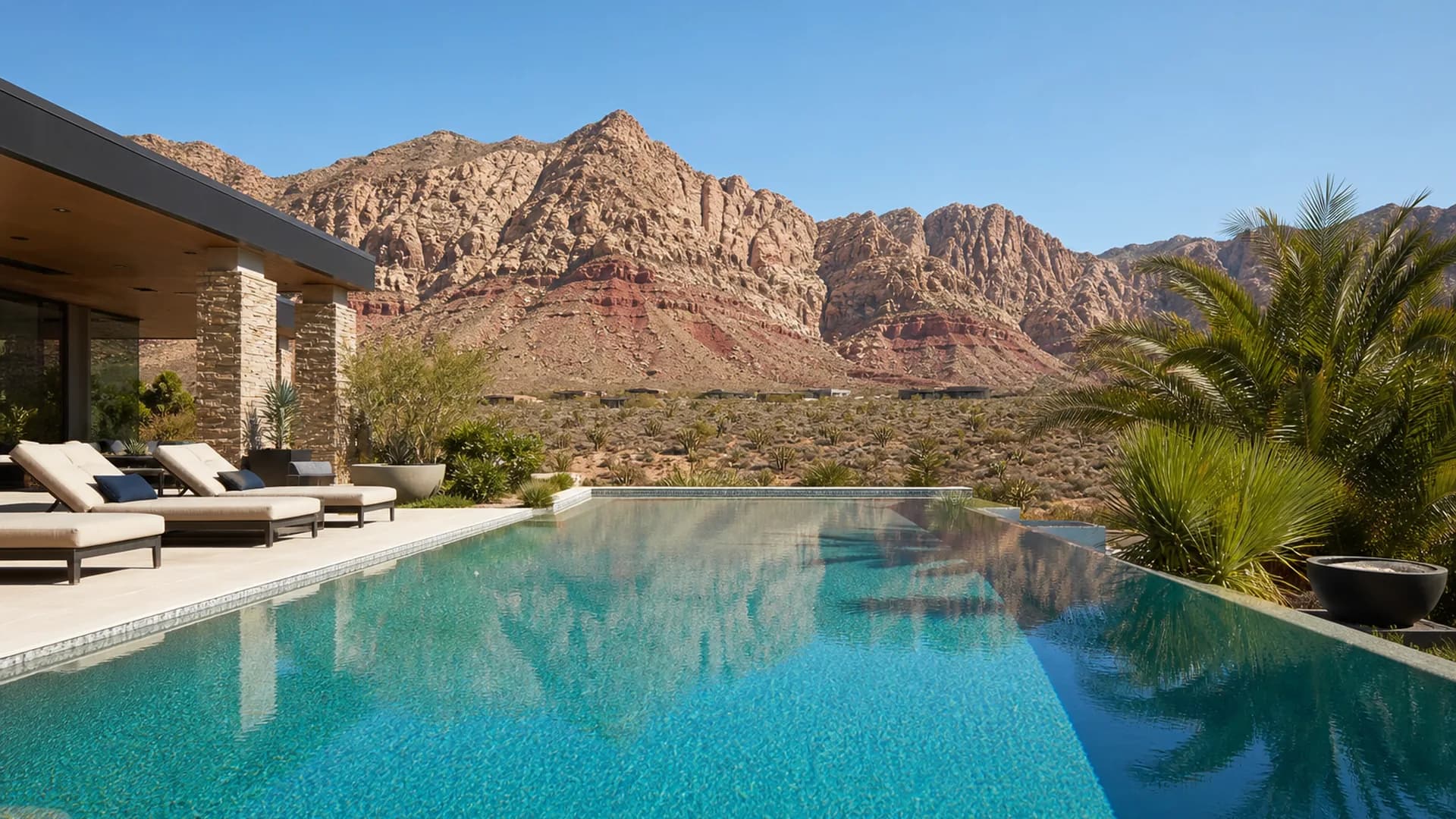 Desert luxury pool with Red Rock mountains under a clear dry sky | Las Vegas Relocation Services Desert luxury pool with Red Rock mountains under a clear dry sky