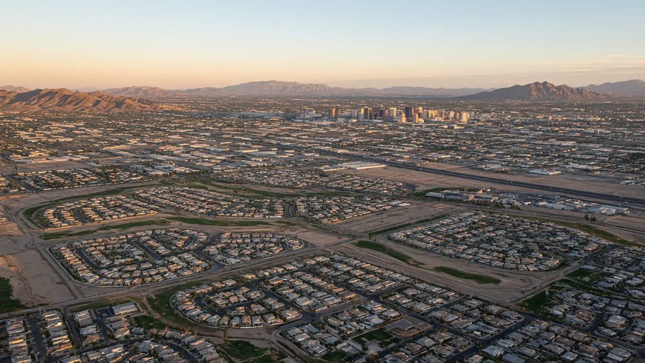 Las Vegas valley neighborhoods with desert mountains and tile-roof homes | Las Vegas Relocation Services Las Vegas valley neighborhoods with desert mountains and tile-roof homes